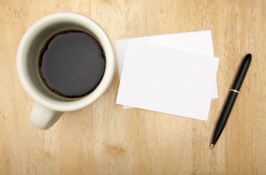 5795958 - blank note card, pen and coffee cup on wood background.